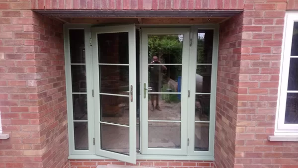 Chartwell Green PVCu French Doors with Astragal Bar and Side Screens for the Shutt's of Ta
