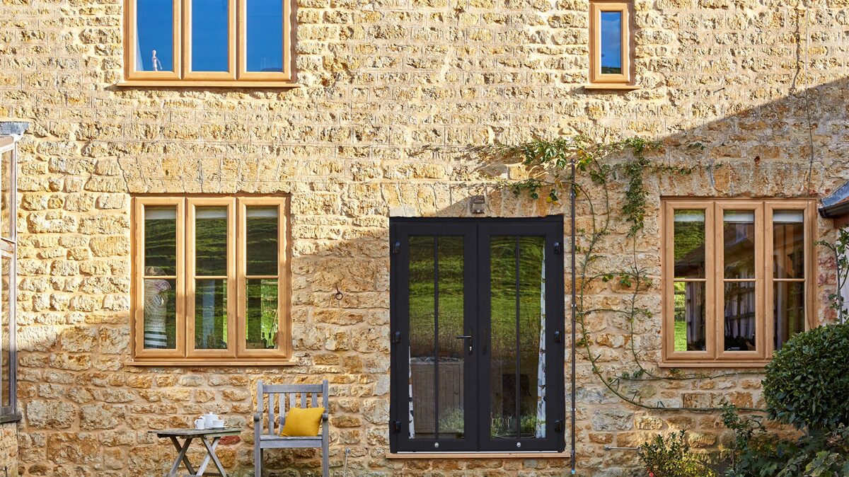 Anthracite Grey uPVC French Doors with Irish Oak Windows in Stone Cotswold style Cottage
