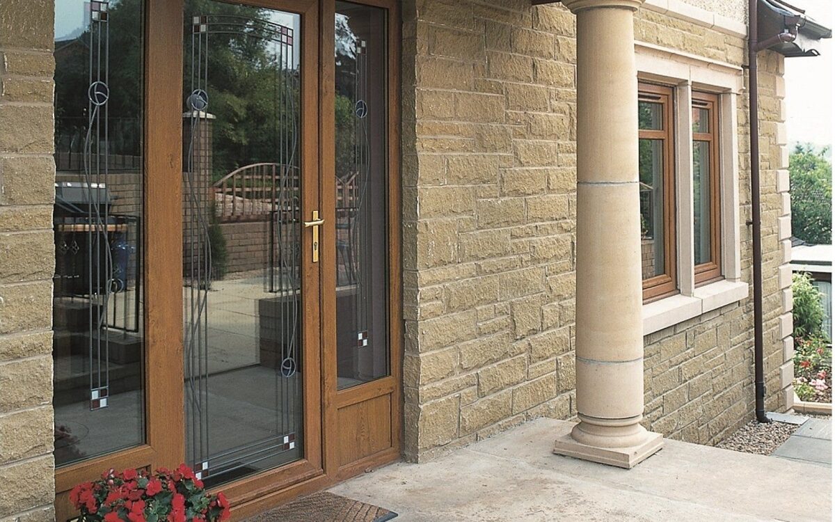 Golden Oak uPVC Doors and Side Screens and Casement Windows on Cotswold Stone style House