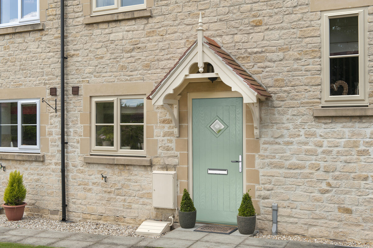 Gallery44 Composite Door in Chartwell Green in Cotswold Stone House with Cream Windows